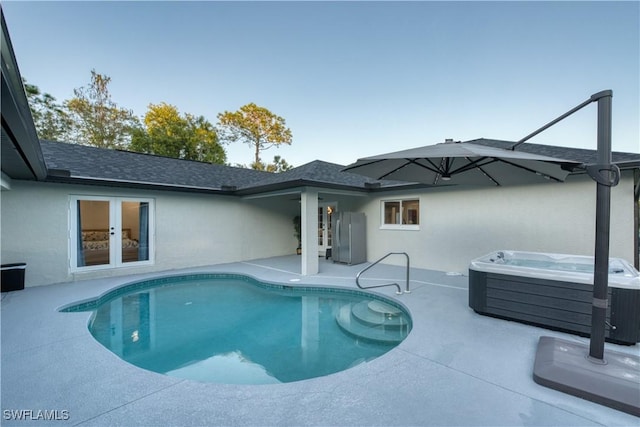 view of pool featuring french doors, a hot tub, and a patio area