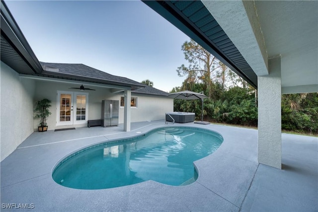 view of swimming pool featuring a patio area, a hot tub, french doors, and ceiling fan