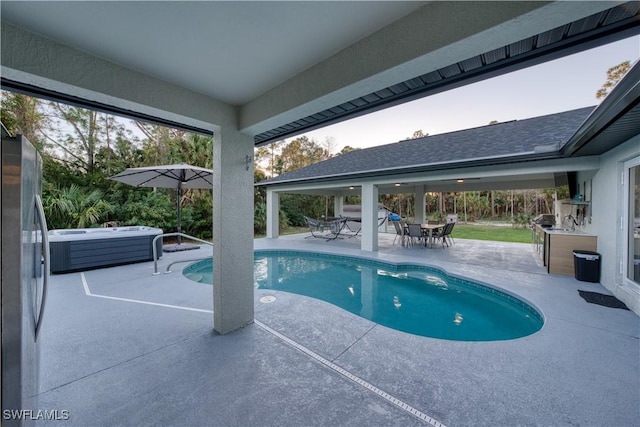 view of swimming pool with a hot tub and a patio