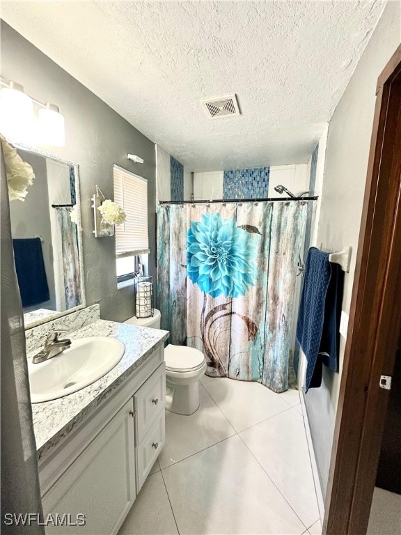 bathroom with tile patterned floors, toilet, a textured ceiling, vanity, and a shower with shower curtain