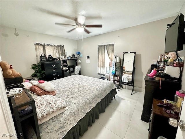 bedroom with ceiling fan and light tile patterned floors