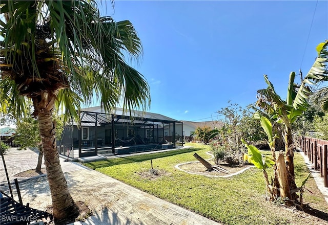 view of yard with a pool and a lanai