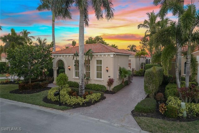 mediterranean / spanish house featuring a yard