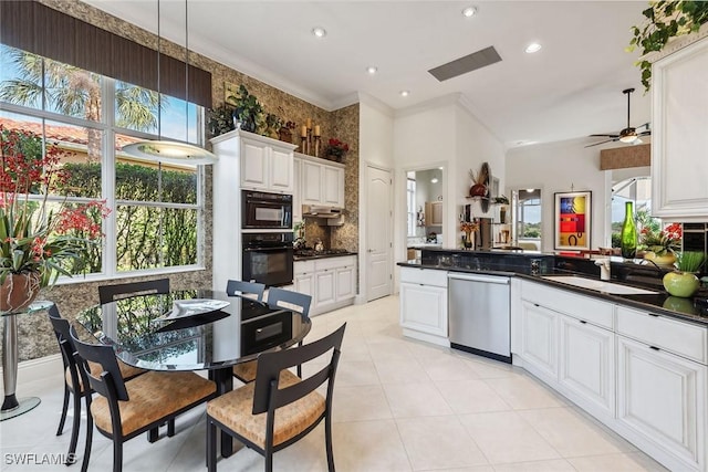 kitchen featuring crown molding, kitchen peninsula, white cabinets, stainless steel dishwasher, and oven