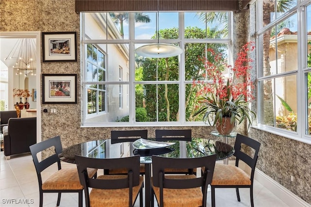 dining area with a chandelier and light tile patterned flooring