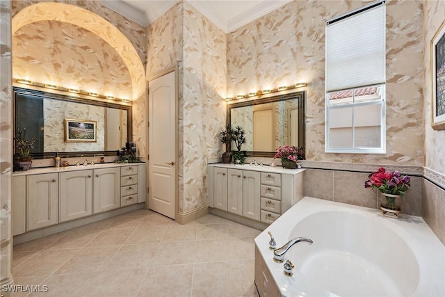 bathroom with tile patterned flooring, ornamental molding, a bath, and vanity