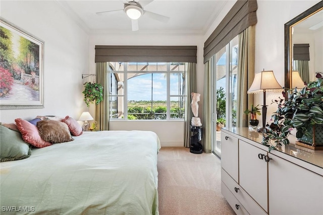 carpeted bedroom with ceiling fan, ornamental molding, and multiple windows