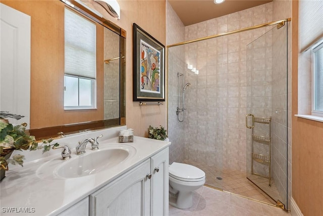 bathroom with vanity, tile patterned floors, a shower with door, and toilet