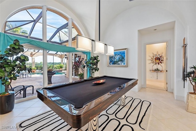 recreation room featuring light tile patterned flooring and high vaulted ceiling