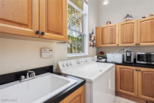 washroom featuring cabinets, separate washer and dryer, and sink