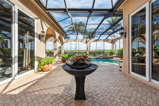 view of patio / terrace featuring glass enclosure