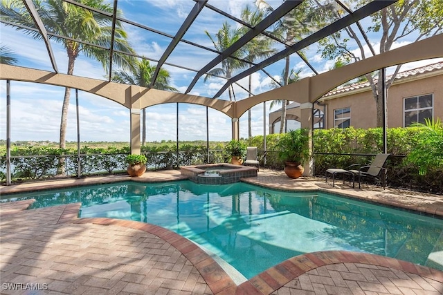 view of pool featuring an in ground hot tub, a patio, and glass enclosure