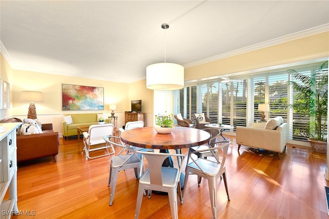 dining area featuring ornamental molding and hardwood / wood-style floors