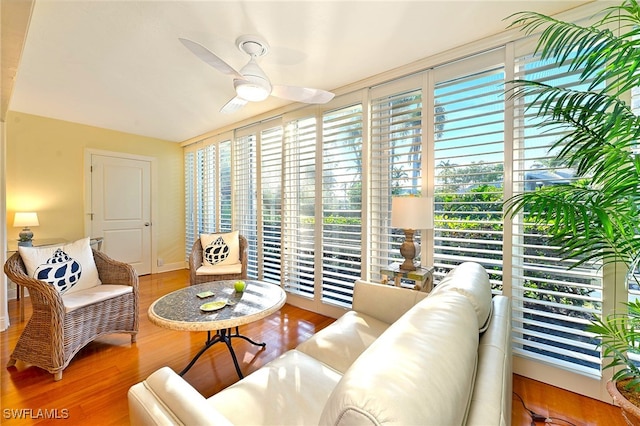 living room with hardwood / wood-style flooring and ceiling fan