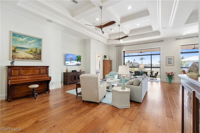 living room featuring beamed ceiling, a high ceiling, coffered ceiling, light hardwood / wood-style floors, and crown molding