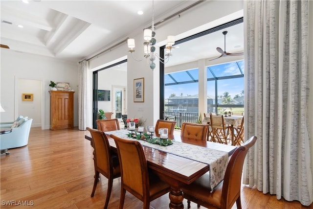 dining area with ceiling fan with notable chandelier and light wood-type flooring