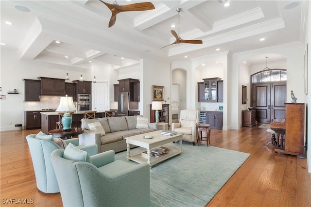 living room with ceiling fan, coffered ceiling, and light hardwood / wood-style flooring