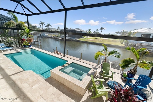 view of swimming pool with an in ground hot tub, a water view, glass enclosure, and a patio