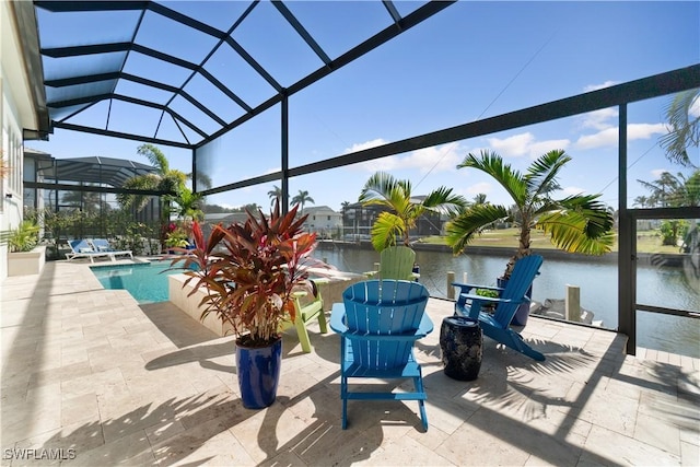 view of patio with glass enclosure and a water view