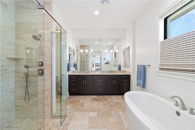 bathroom featuring plus walk in shower and vanity