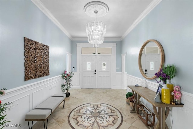 foyer with an inviting chandelier and crown molding