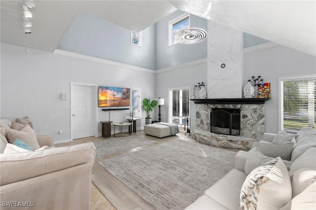 living room with a fireplace, high vaulted ceiling, and light wood-type flooring