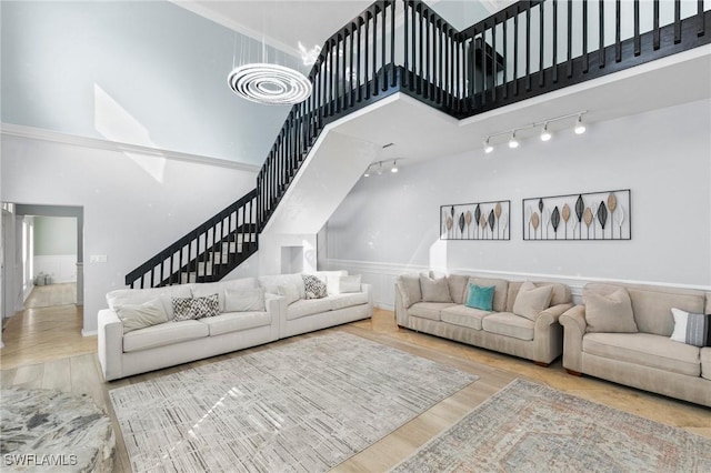 living room featuring a towering ceiling and hardwood / wood-style floors