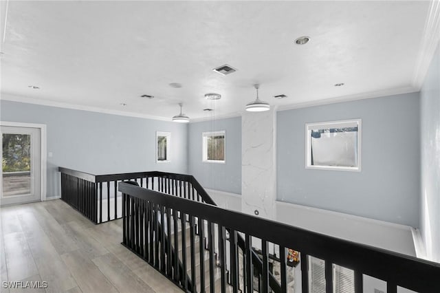 hall with crown molding and light hardwood / wood-style flooring