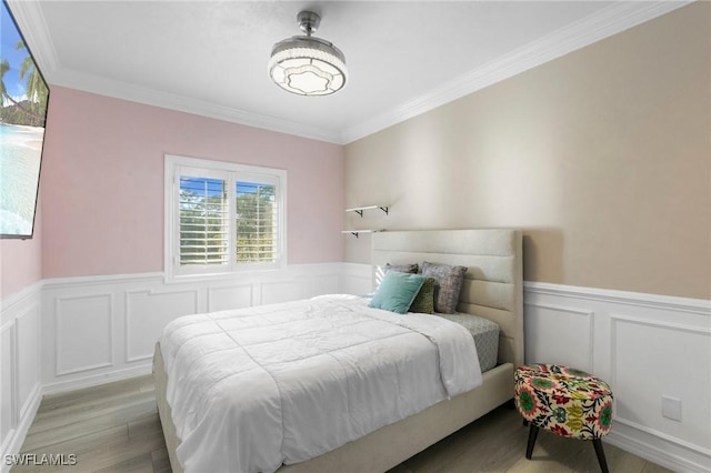 bedroom featuring crown molding and light hardwood / wood-style flooring