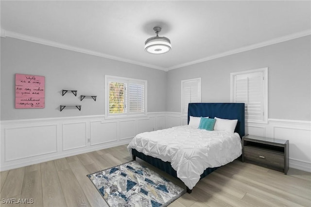 bedroom featuring crown molding and light wood-type flooring