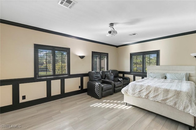 bedroom with crown molding and light hardwood / wood-style flooring