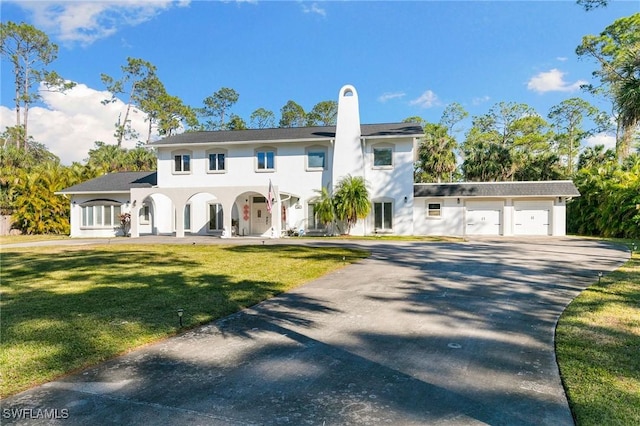 view of front of property featuring a garage and a front yard