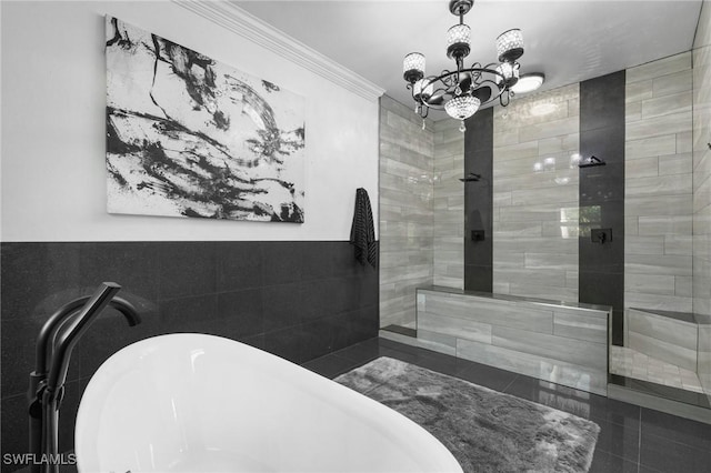 bathroom with crown molding, shower with separate bathtub, an inviting chandelier, and tile walls