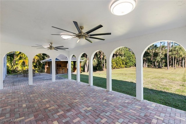 view of patio with exterior bar and ceiling fan