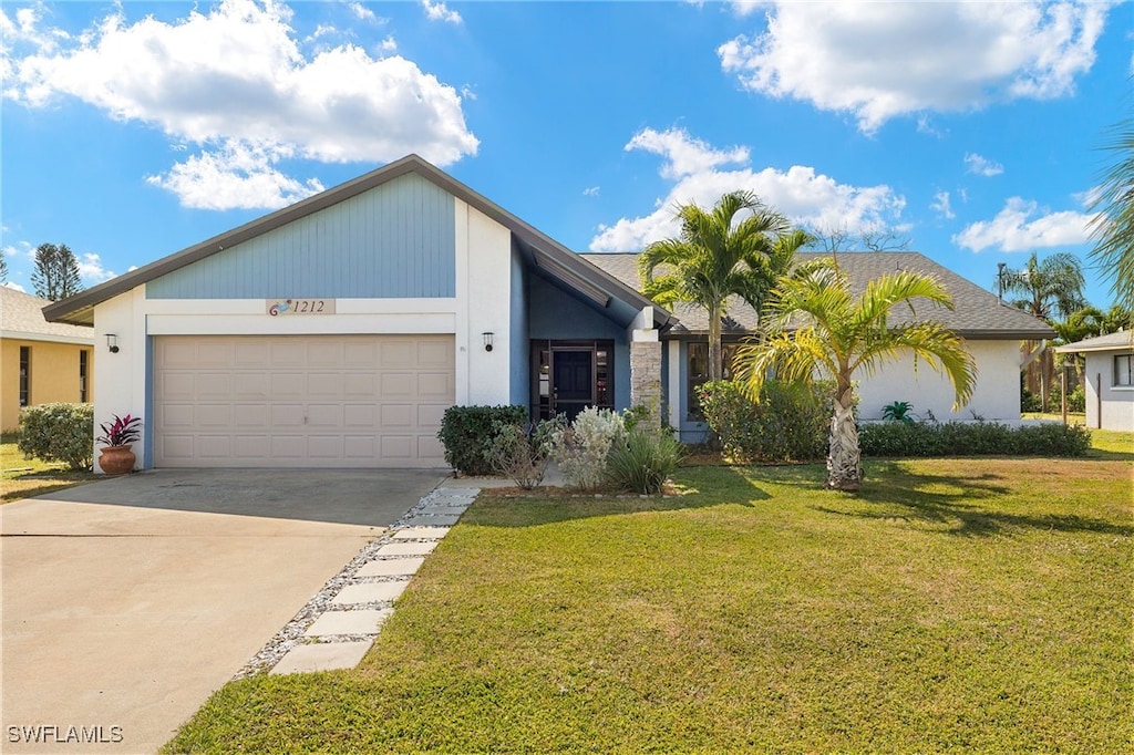 view of front of home featuring a garage and a front lawn