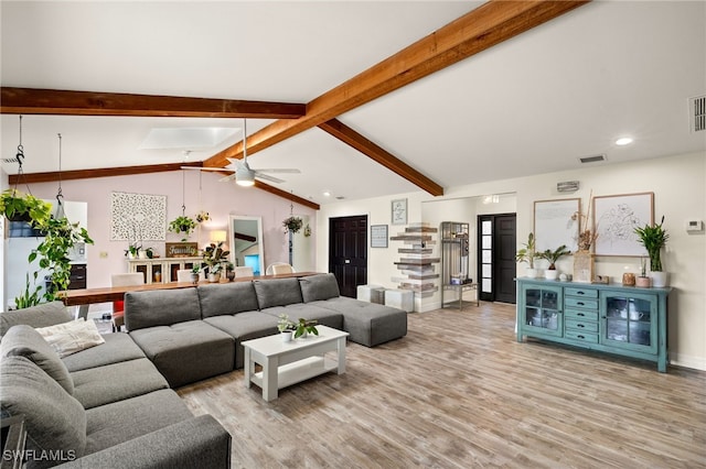 living room featuring lofted ceiling with beams, light hardwood / wood-style floors, and ceiling fan