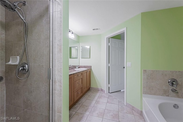 bathroom featuring vanity, plus walk in shower, and tile patterned flooring