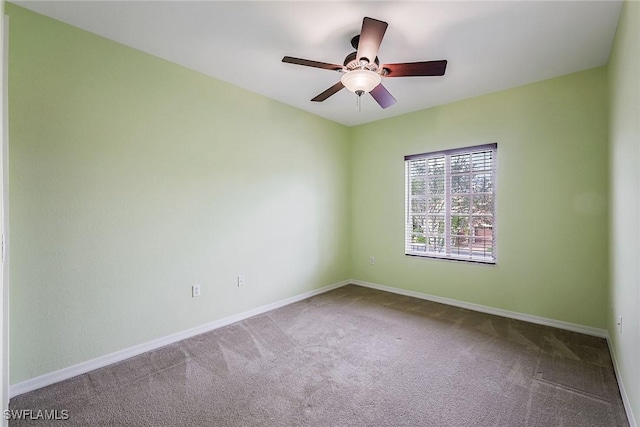 spare room with ceiling fan and carpet flooring