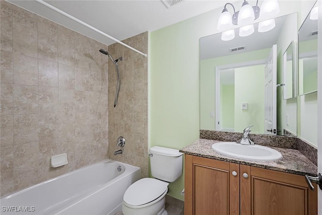 full bathroom featuring vanity, toilet, and tiled shower / bath combo