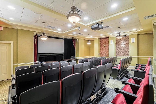 home theater room with ornamental molding and carpet floors