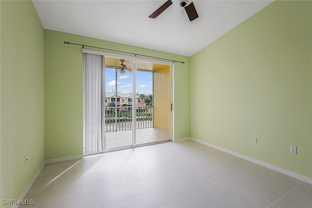 unfurnished room featuring a ceiling fan, baseboards, and light tile patterned floors