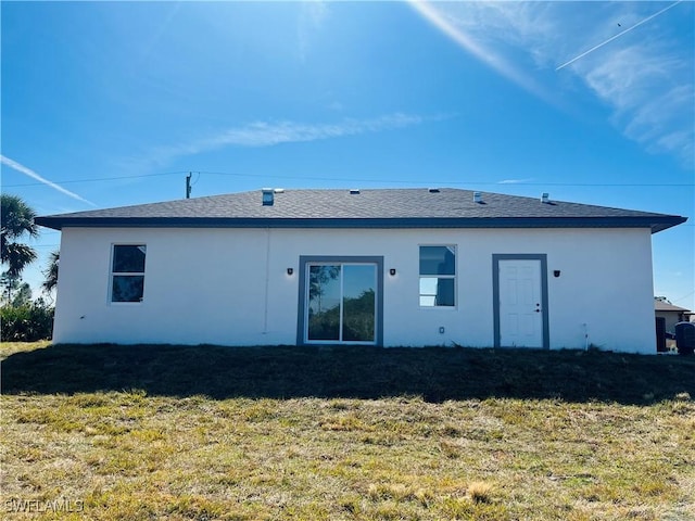 rear view of property with a yard