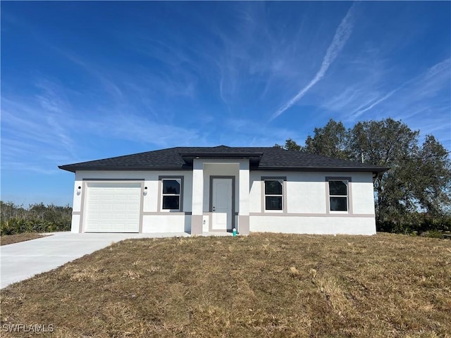 view of front of home featuring a garage and a front lawn