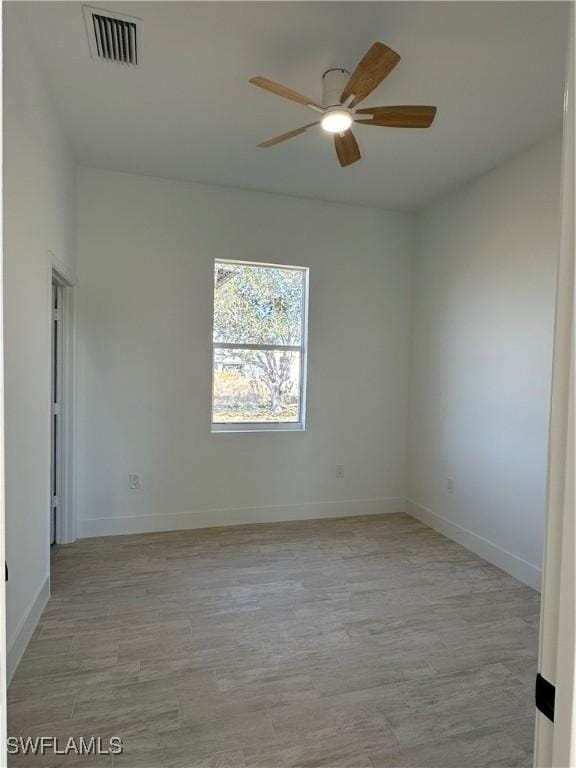 spare room with ceiling fan and light hardwood / wood-style flooring