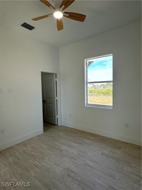 empty room with ceiling fan and light wood-type flooring