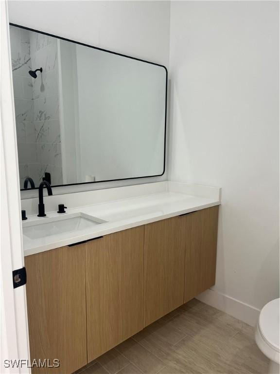 bathroom featuring vanity and toilet