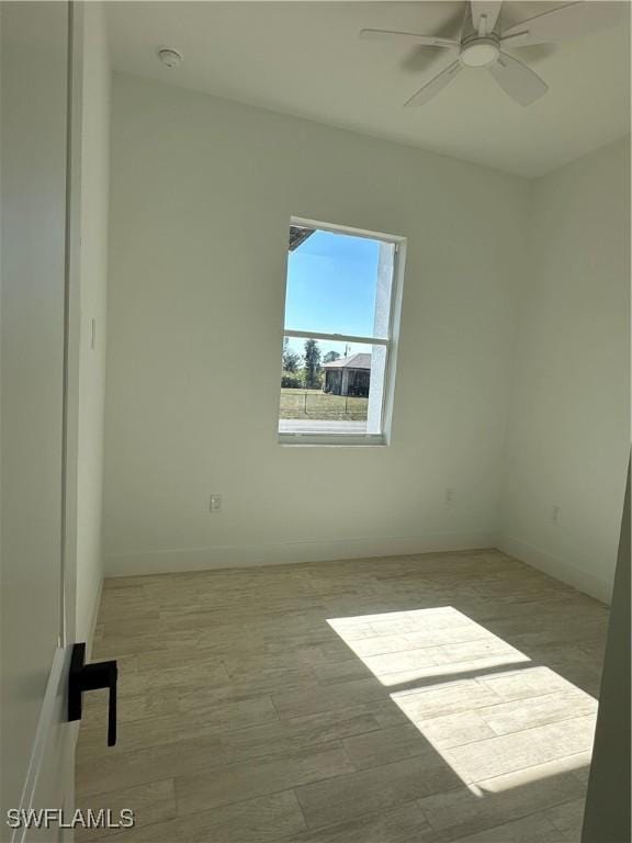 empty room featuring ceiling fan and light hardwood / wood-style flooring