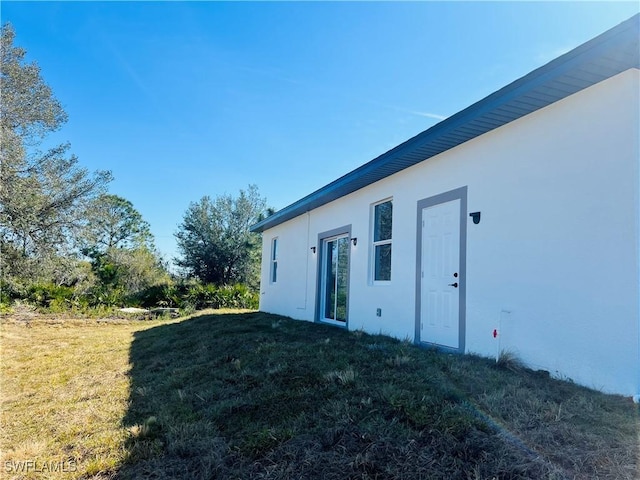 view of home's exterior with a lawn