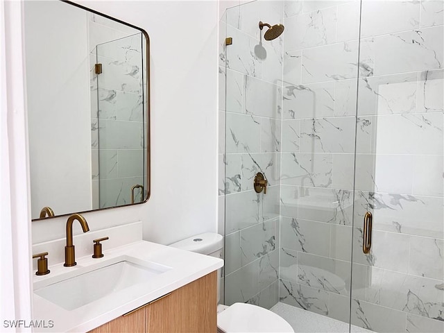 bathroom with vanity, toilet, and a shower with shower door