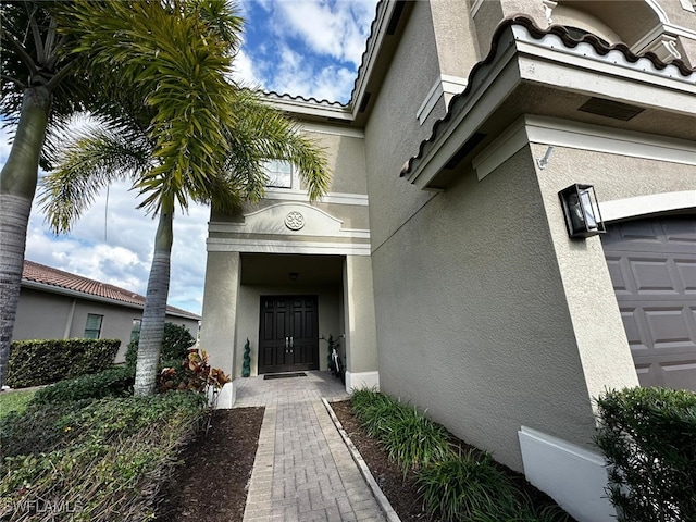 view of exterior entry featuring a garage